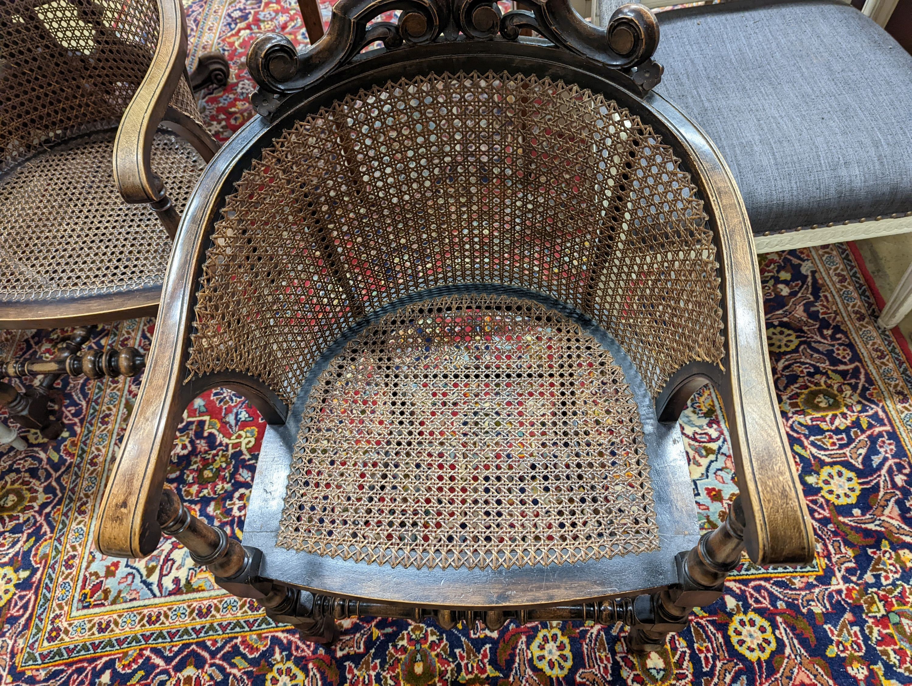 A pair of early 20th century Carolean style caned beech tub framed chairs, width 56cm, depth 48cm, height 85cm